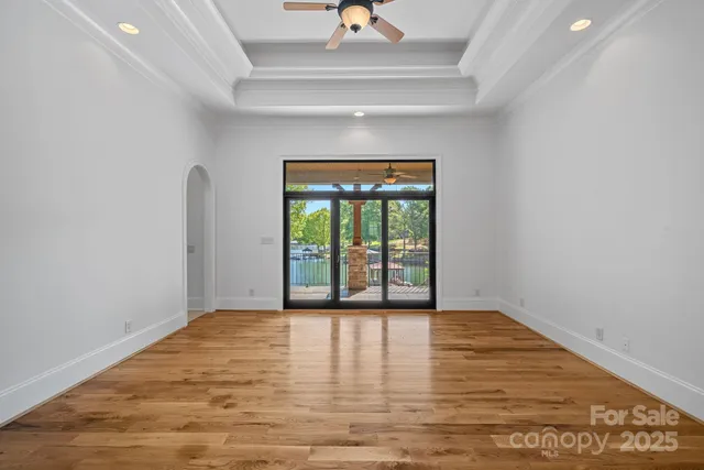 a living room with granite countertop a swimming pool and a large window