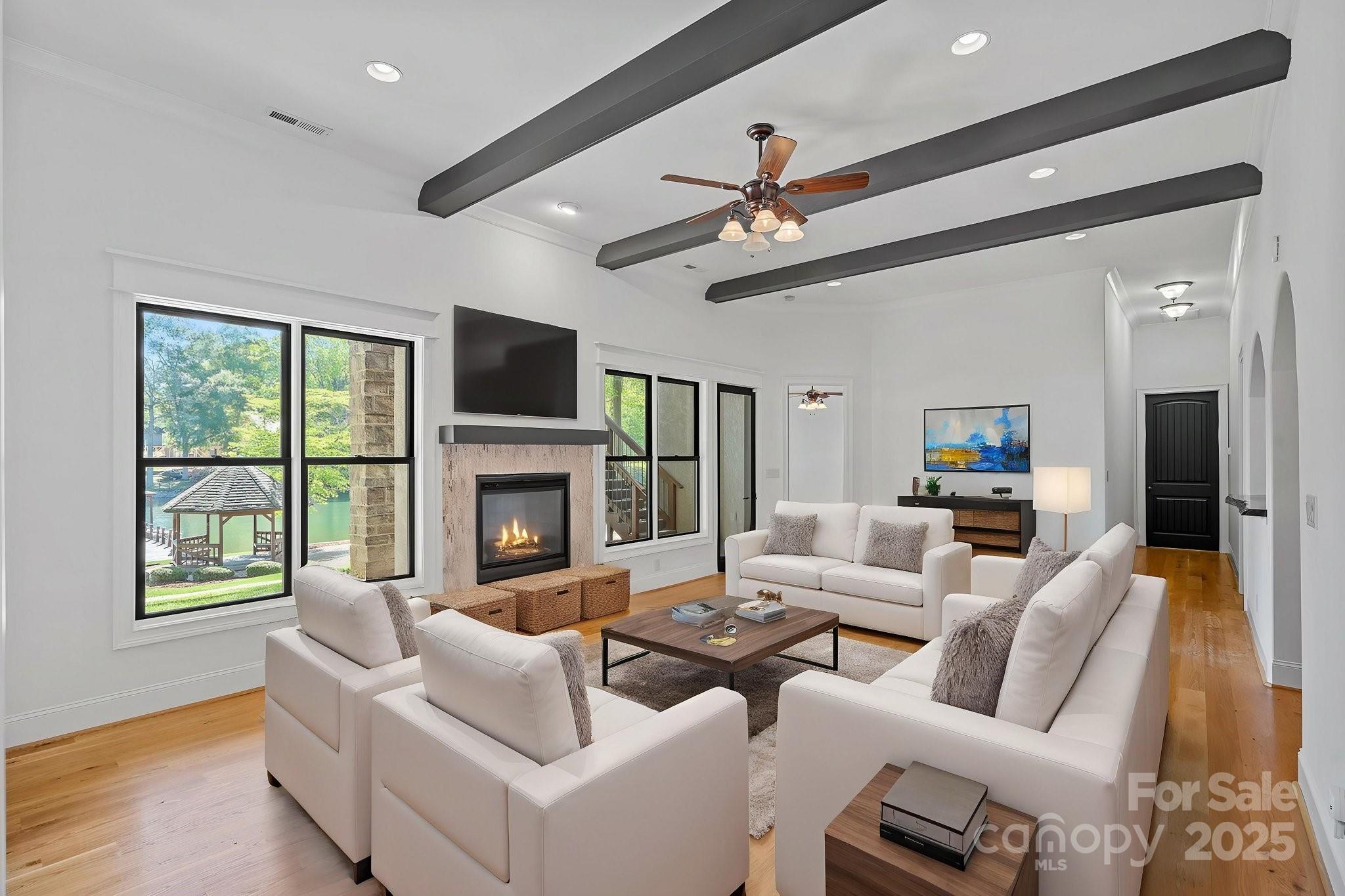 4786 Heather Lane Denver, NC 28037 - Photo 30 of 48 a living room with furniture a fireplace and a flat screen tv