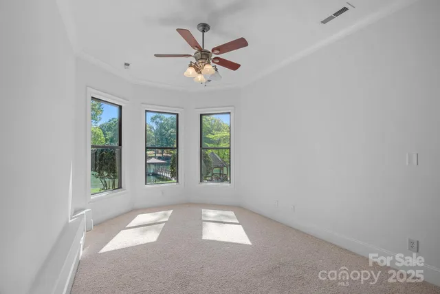 a bathroom with a granite countertop sink a mirror and a toilet