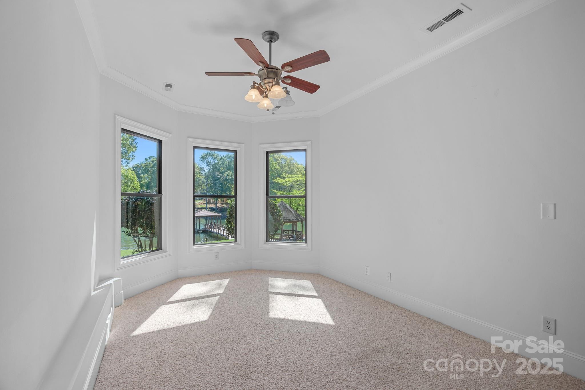 4786 Heather Lane Denver, NC 28037 - Photo 32 of 48 an empty room with windows and fan