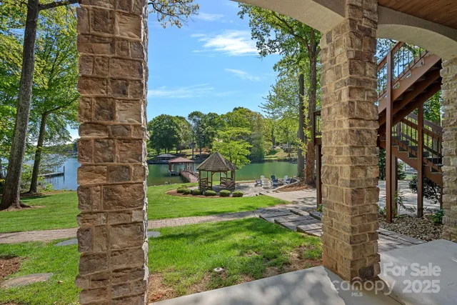 a view of a balcony with wooden floor and outdoor seating