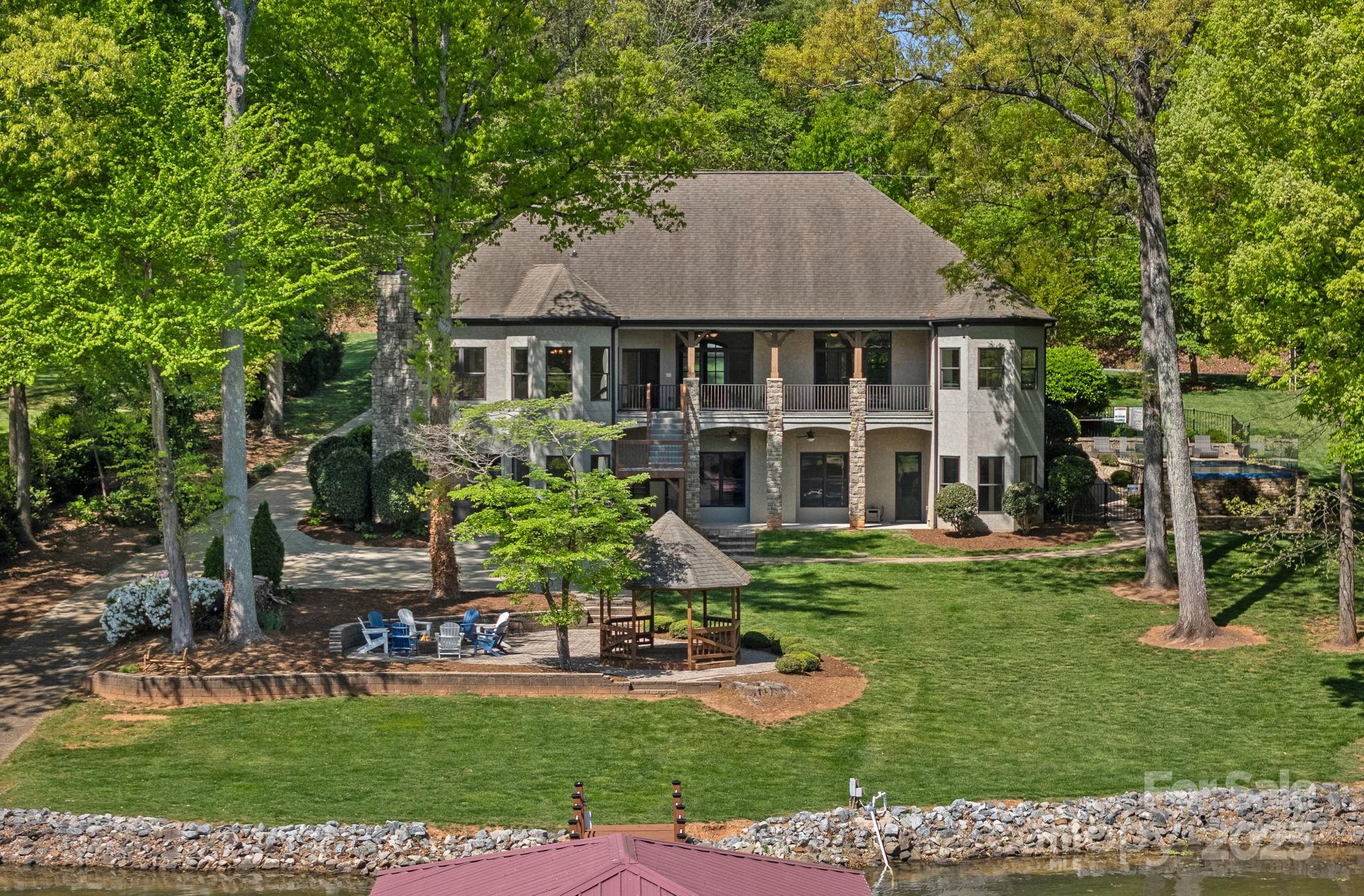 4786 Heather Lane Denver, NC 28037 - Photo 4 of 48 a front view of a house with a yard table and chairs