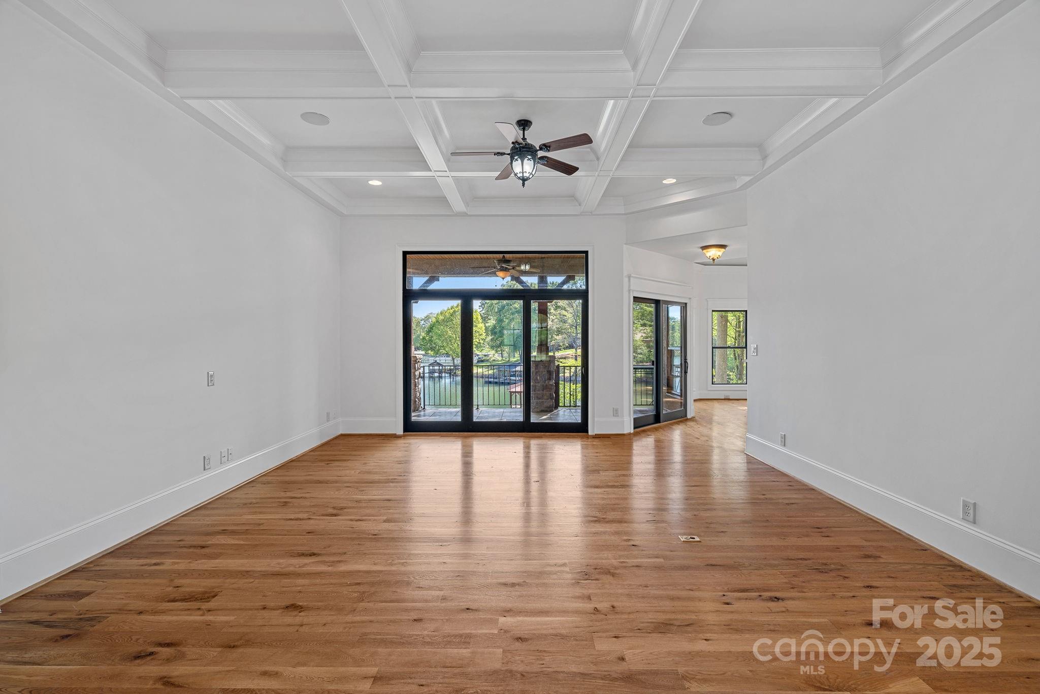 4786 Heather Lane Denver, NC 28037 - Photo 10 of 48 an empty room with wooden floor and a ceiling fan