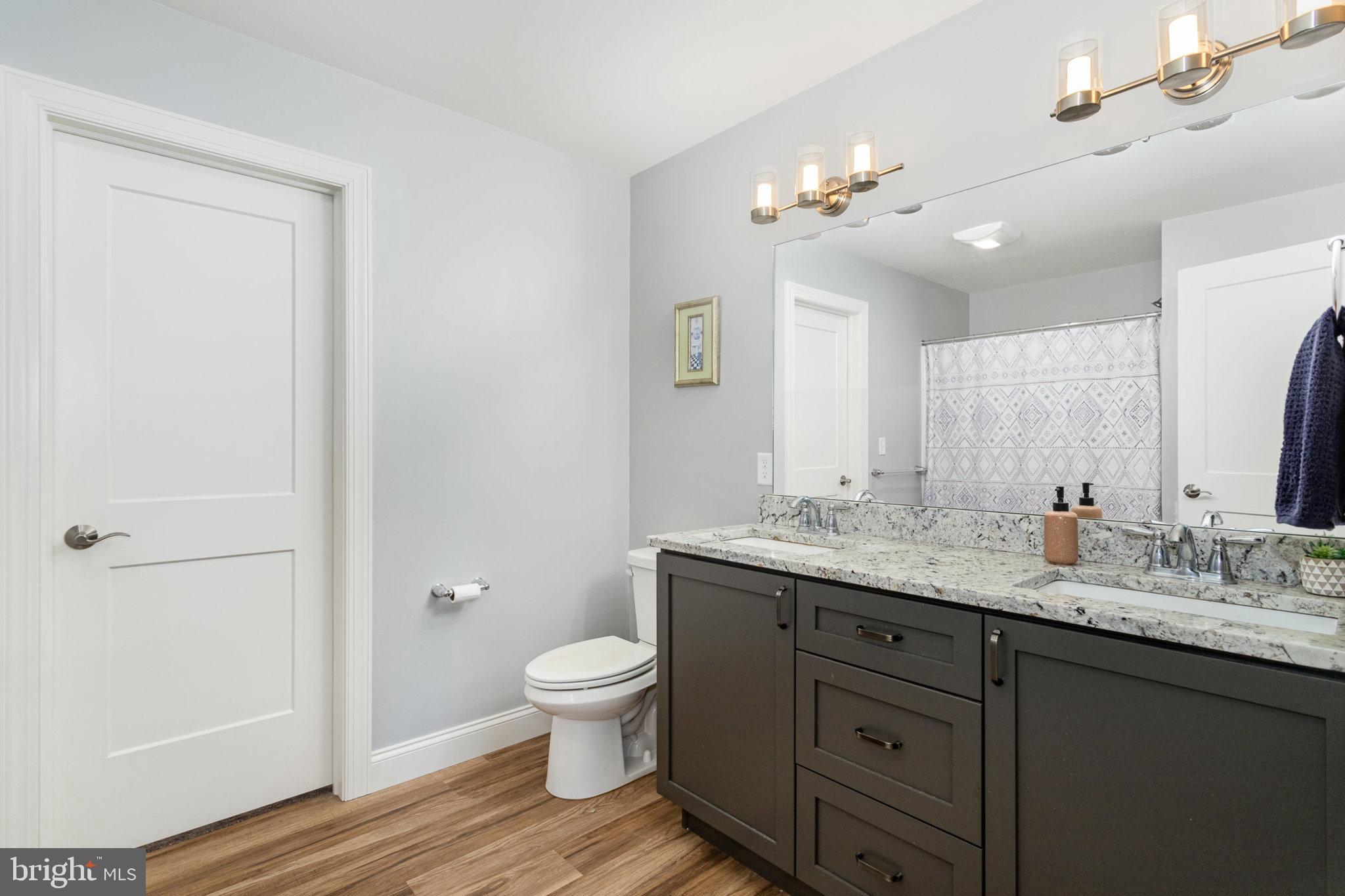 309 Pierson Road Lititz, PA 17543 - Photo 13 of 24 a bathroom with a granite countertop sink a toilet and a shower