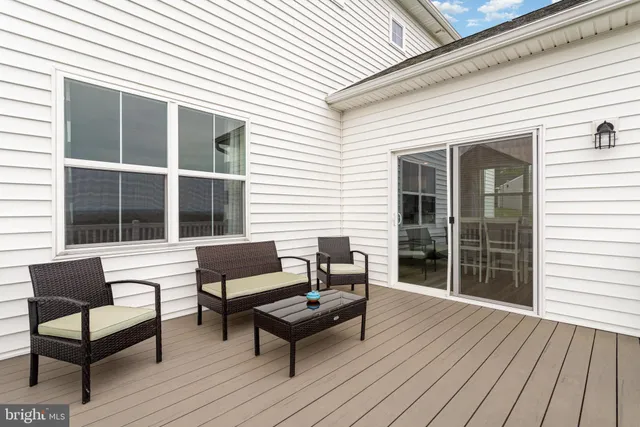 a balcony with wooden floor and a couch