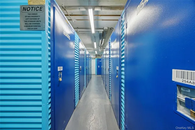 a view of a hallway with wooden floor and windows