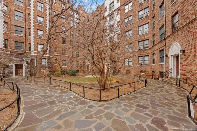 a view of a brick building with many windows