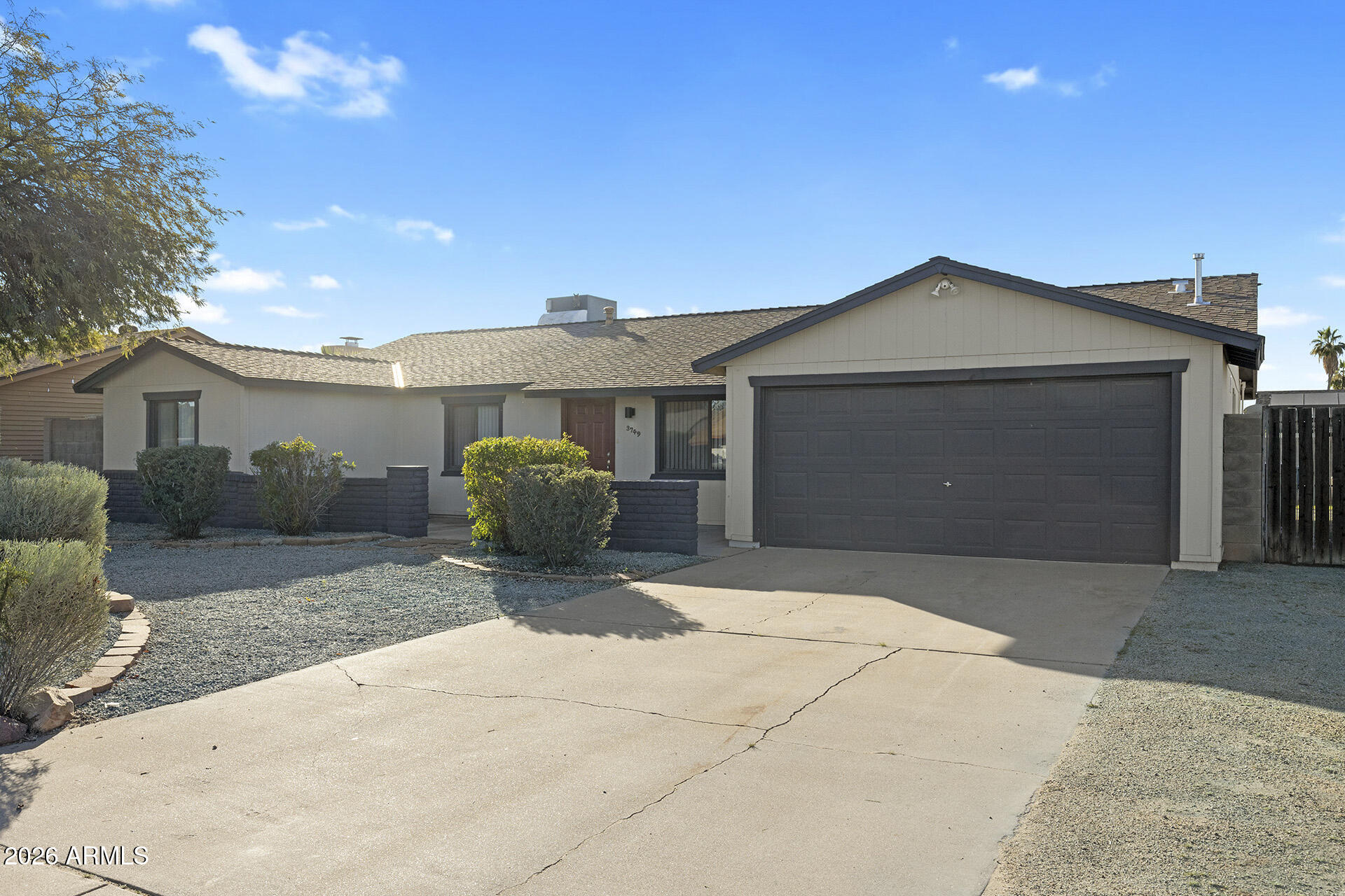 3749 East Pershing Avenue Phoenix, AZ 85032 - Photo 11 of 53 a front view of a house with a yard and garage