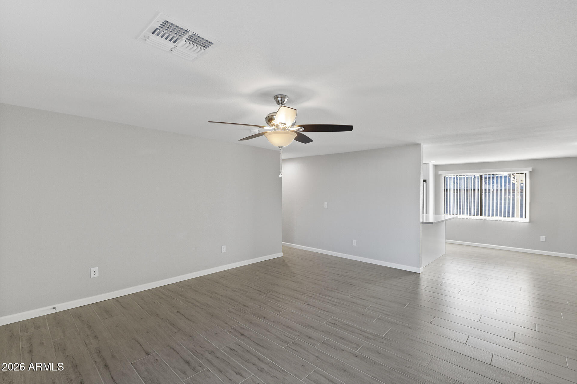 3749 East Pershing Avenue Phoenix, AZ 85032 - Photo 14 of 53 wooden floor in an empty room with a window