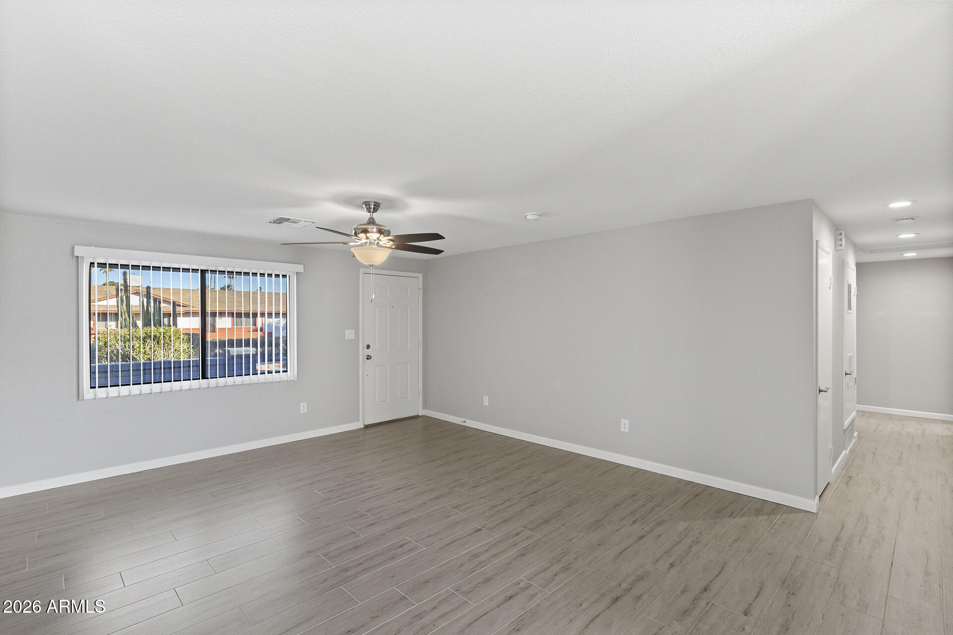 3749 East Pershing Avenue Phoenix, AZ 85032 - Photo 15 of 53 wooden floor in an empty room with a window