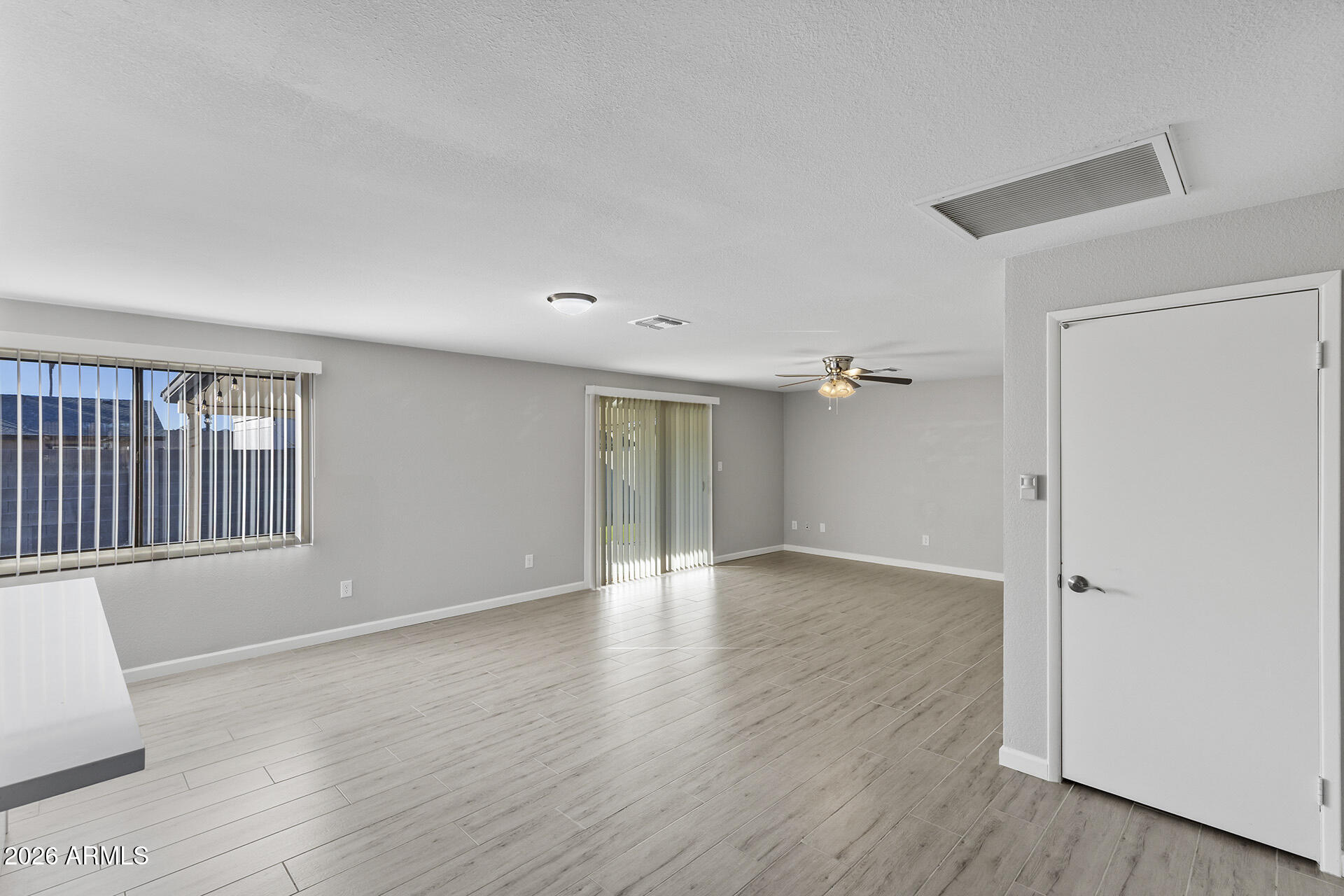 3749 East Pershing Avenue Phoenix, AZ 85032 - Photo 16 of 53 an empty room with wooden floor and windows