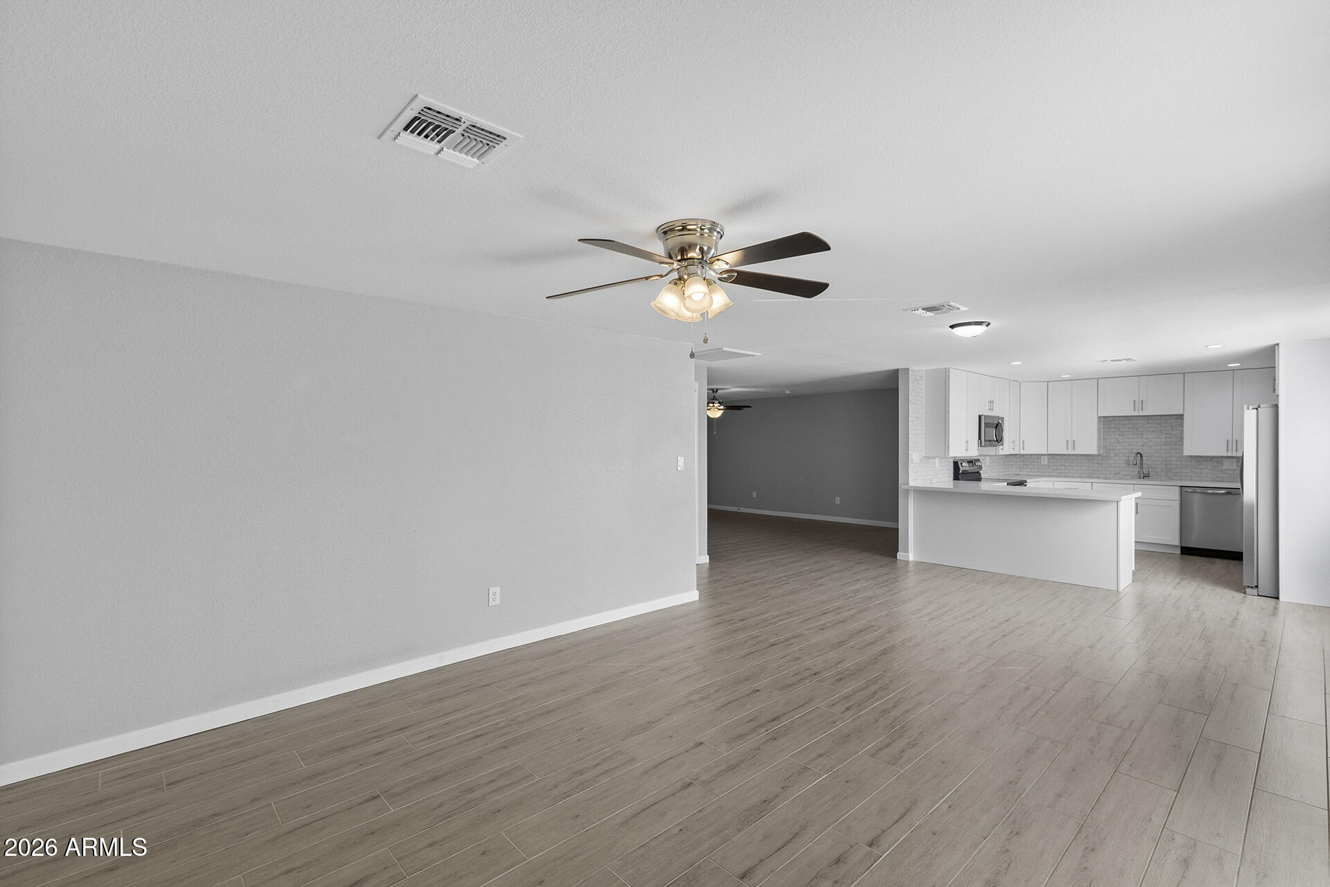 3749 East Pershing Avenue Phoenix, AZ 85032 - Photo 20 of 53 a view of a kitchen with a sink a ceiling fan and stainless steel appliances