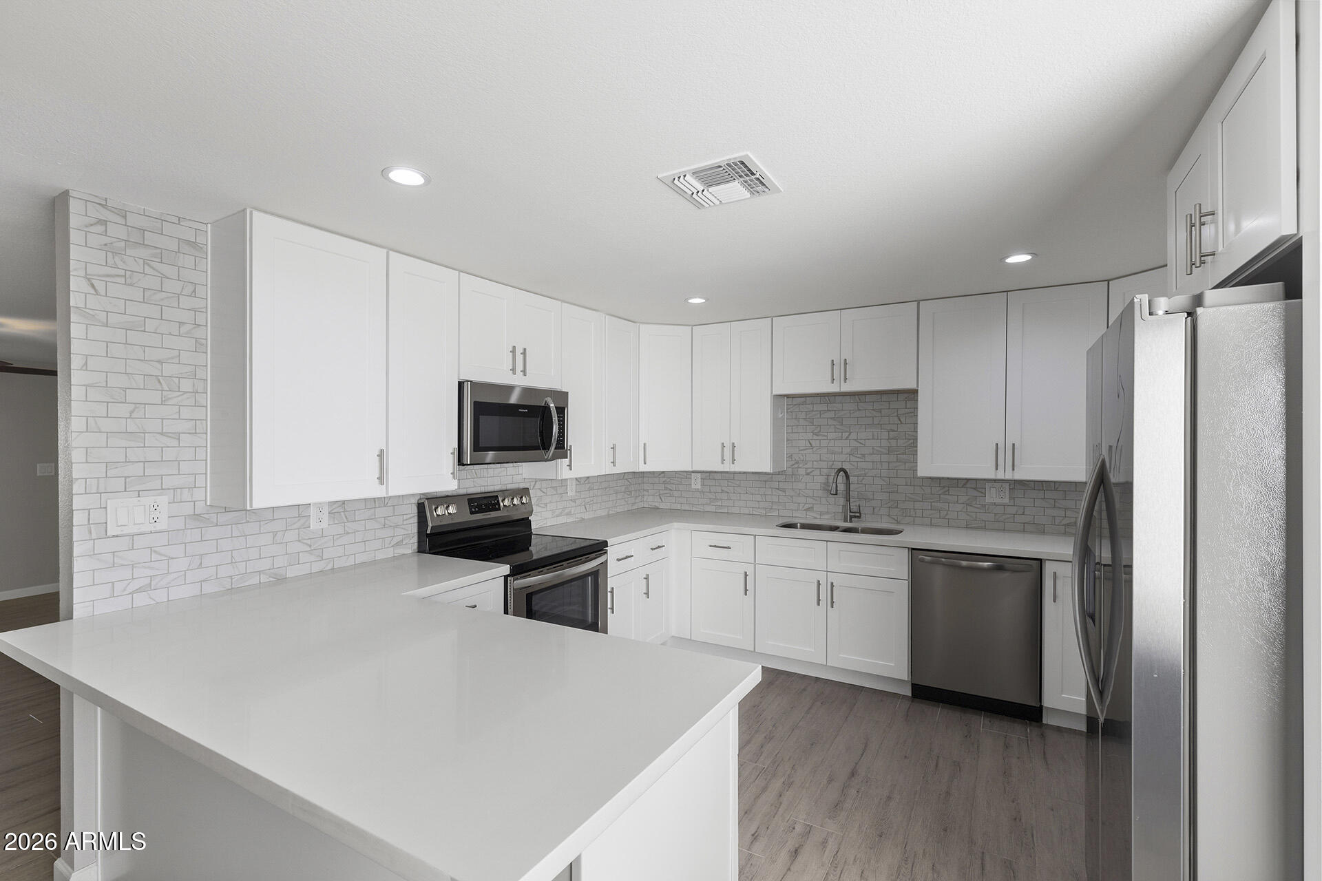 3749 East Pershing Avenue Phoenix, AZ 85032 - Photo 23 of 53 a kitchen with stainless steel appliances a stove sink microwave and cabinets