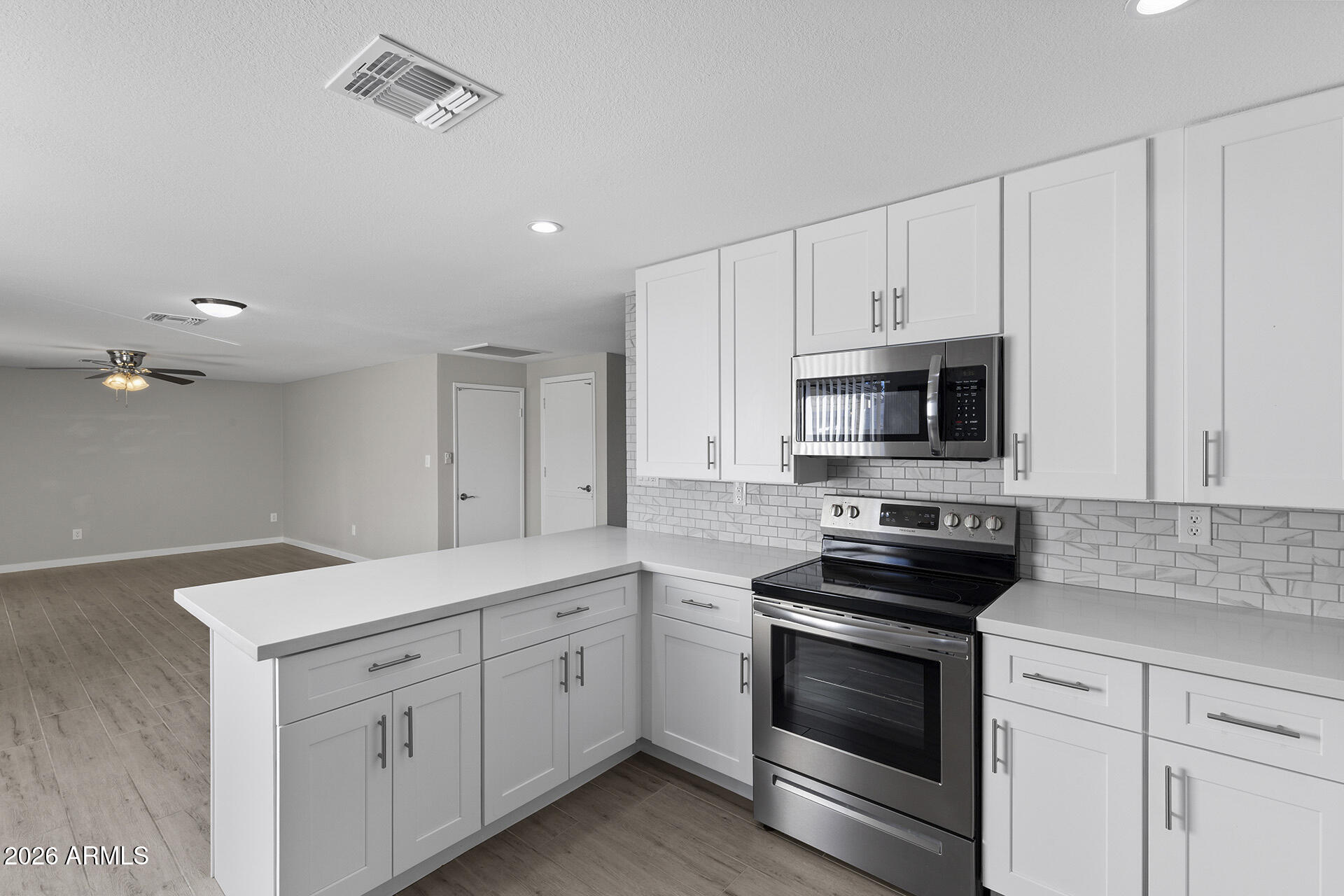 3749 East Pershing Avenue Phoenix, AZ 85032 - Photo 25 of 53 a kitchen with white cabinets stainless steel appliances and sink