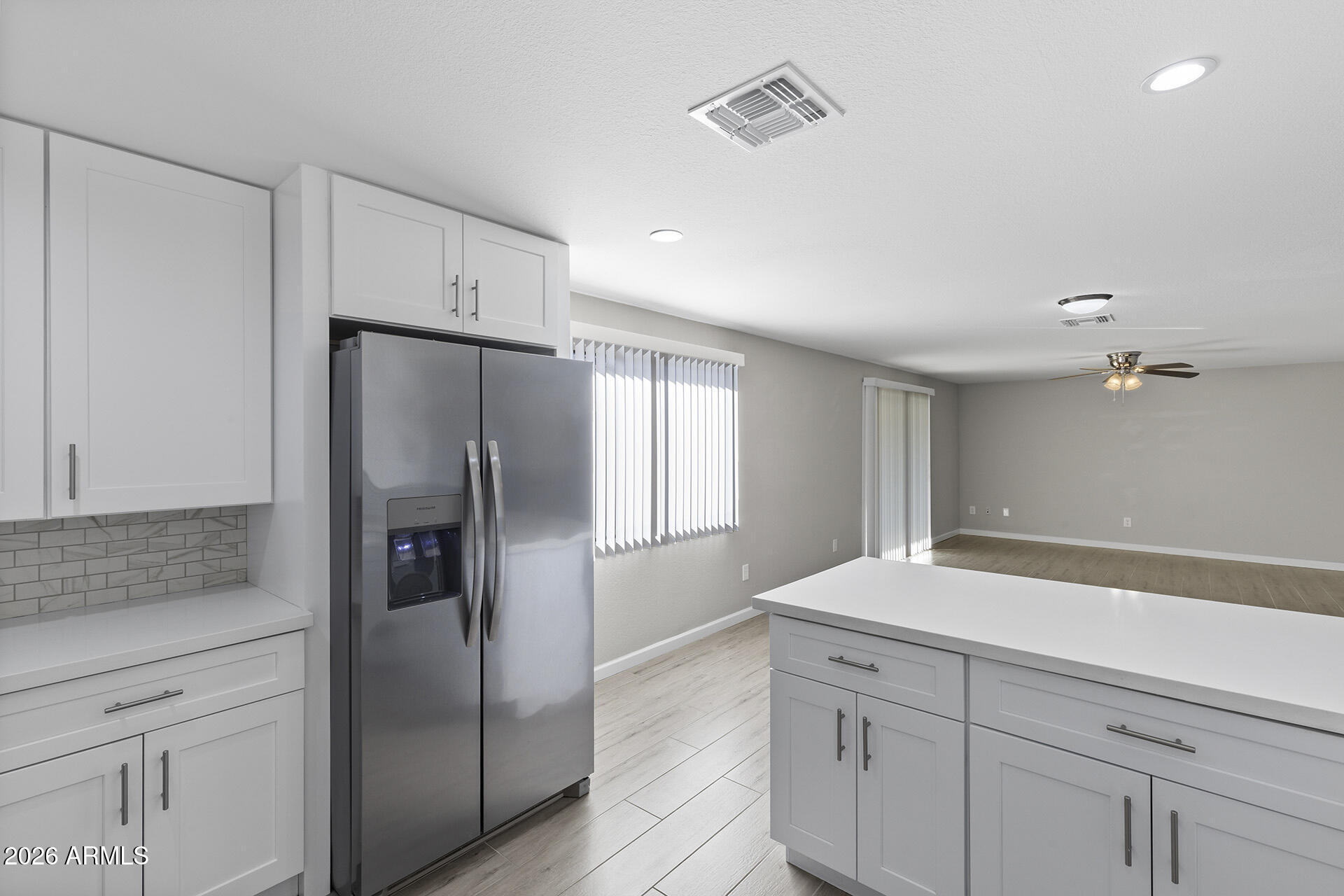 3749 East Pershing Avenue Phoenix, AZ 85032 - Photo 26 of 53 a kitchen with white cabinets and stainless steel appliances