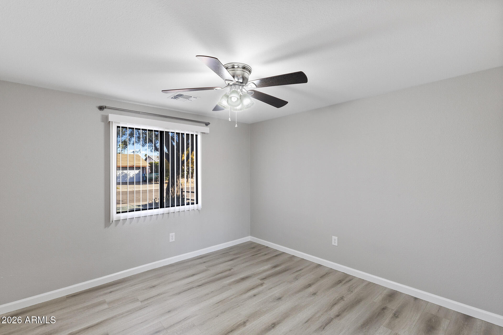 3749 East Pershing Avenue Phoenix, AZ 85032 - Photo 34 of 53 a view of an empty room with a window and a fan