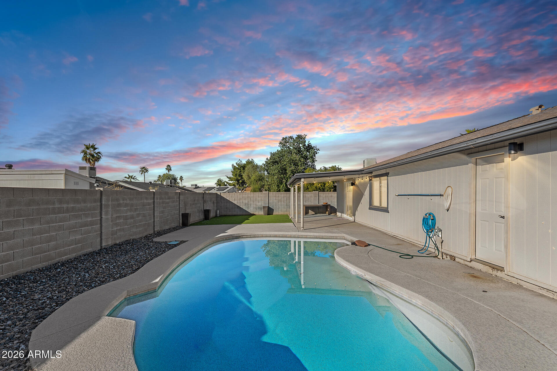 3749 East Pershing Avenue Phoenix, AZ 85032 - Photo 49 of 53 a view of a swimming pool with a lounge chairs