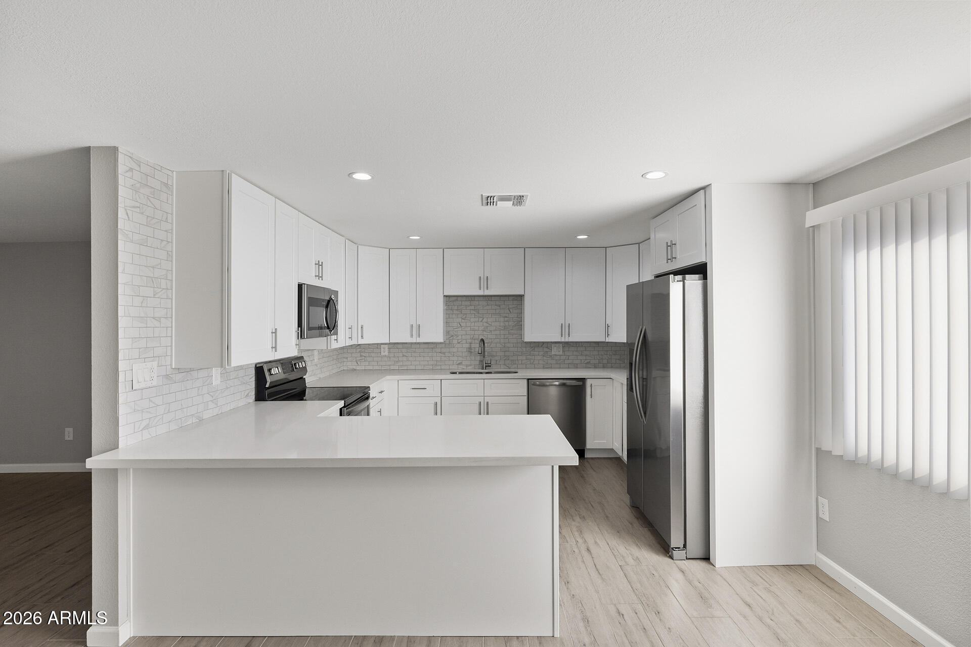 3749 East Pershing Avenue Phoenix, AZ 85032 - Photo 4 of 53 a kitchen with stainless steel appliances a refrigerator sink and microwave