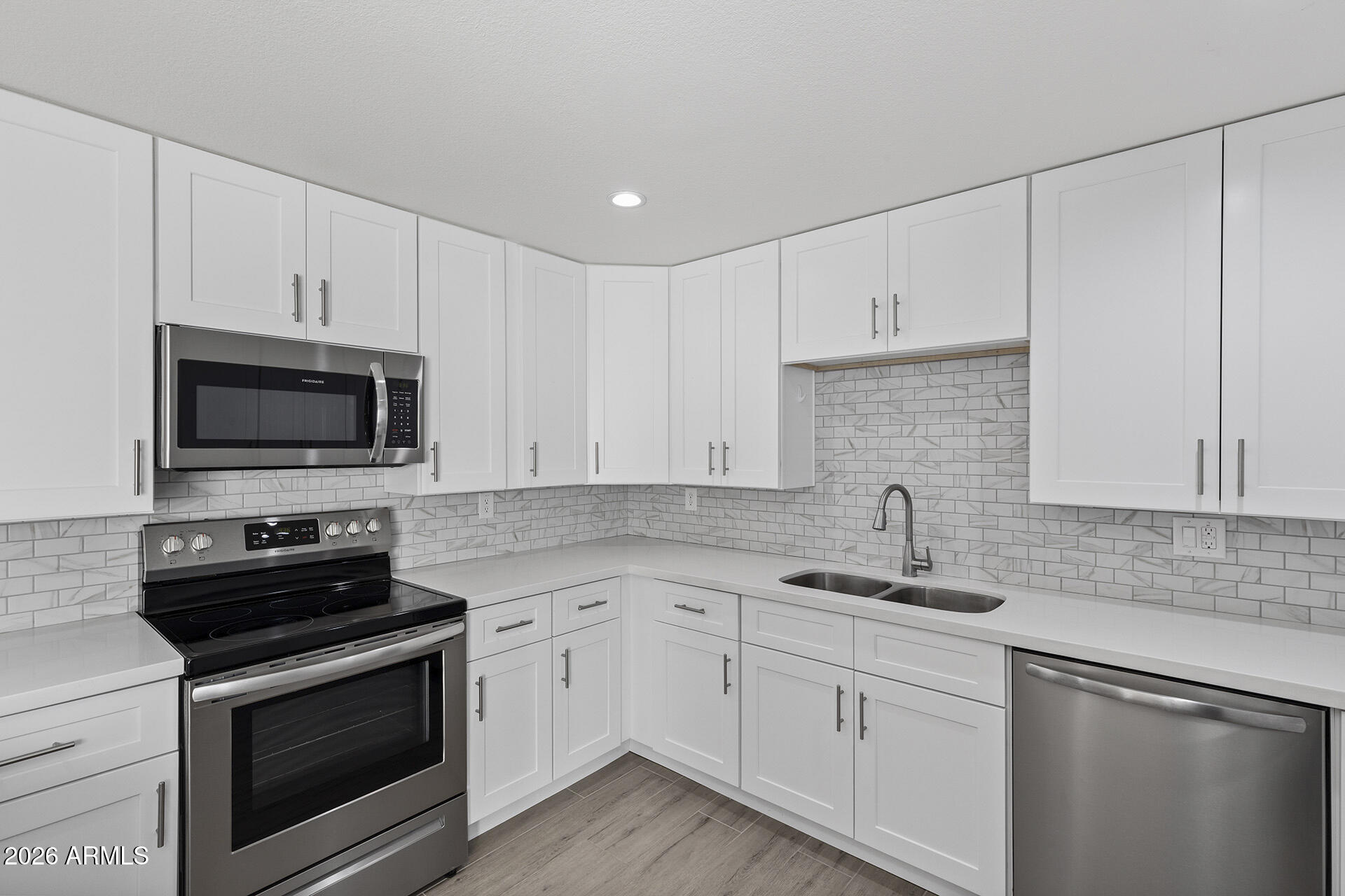 3749 East Pershing Avenue Phoenix, AZ 85032 - Photo 5 of 53 a kitchen with white cabinets and stainless steel appliances