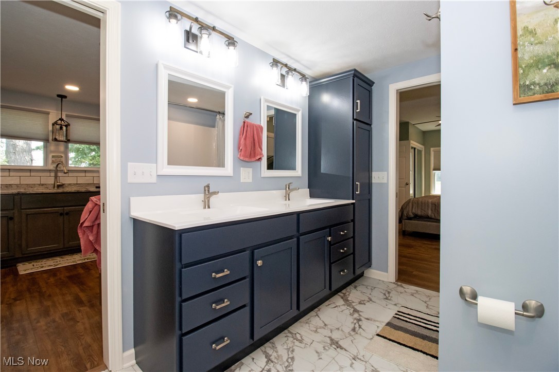 8984 Spencer Road Homerville, OH 44235 - Photo 22 of 27 Bathroom with double vanity and tile patterned floors