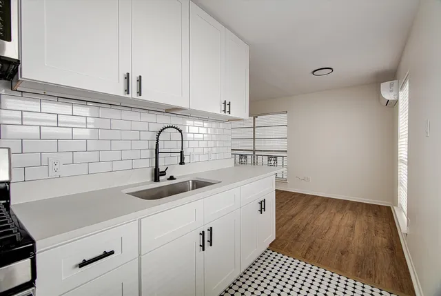 a kitchen with a sink and cabinets