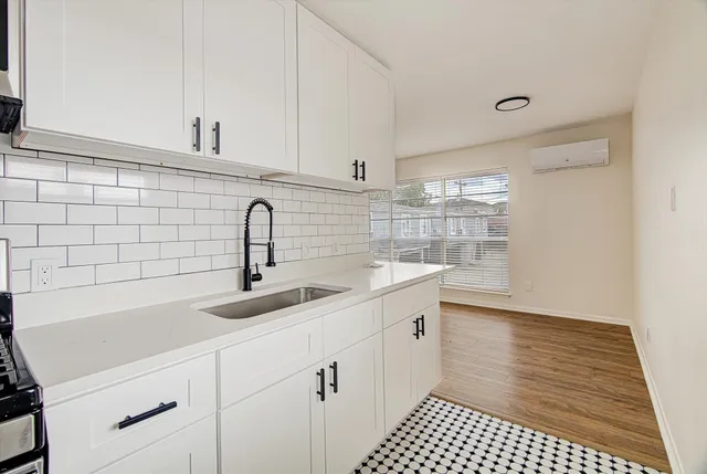 a kitchen with a sink and cabinets