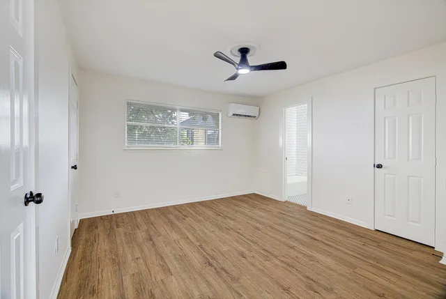a view of a big room with wooden floor and windows in a room