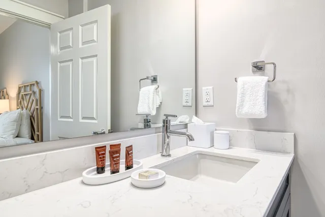 a bathroom with a sink vanity and a mirror