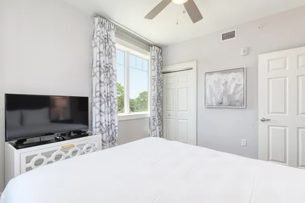 a bedroom with a bed and a painting
