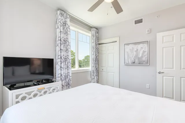 a bedroom with a bed and a painting