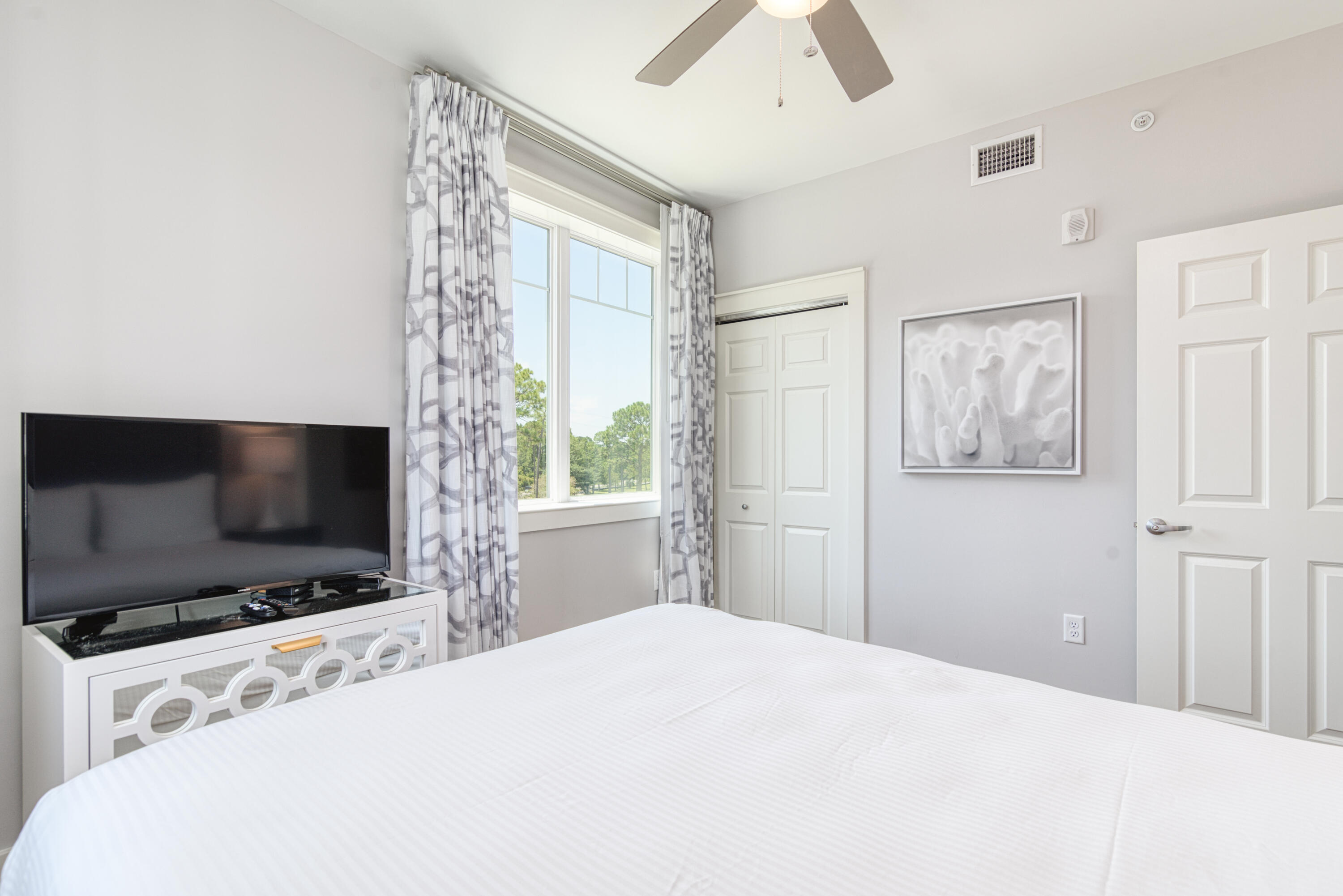 9000 Heron Walk Drive, Unit 3204 Miramar Beach, FL 32550 - Photo 35 of 45 a bedroom with a bed and a flat screen tv