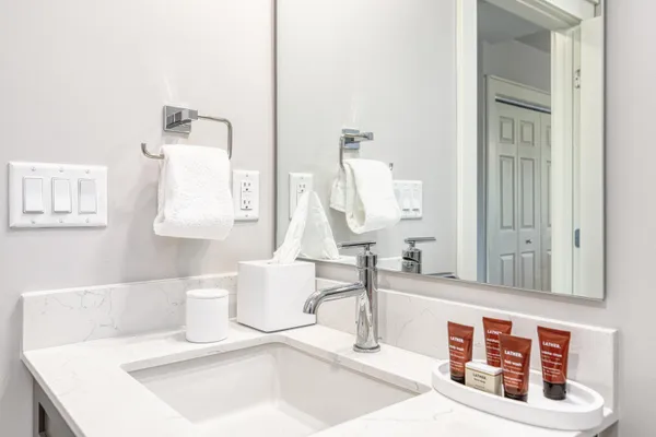 a bathroom with a sink a toilet and shower