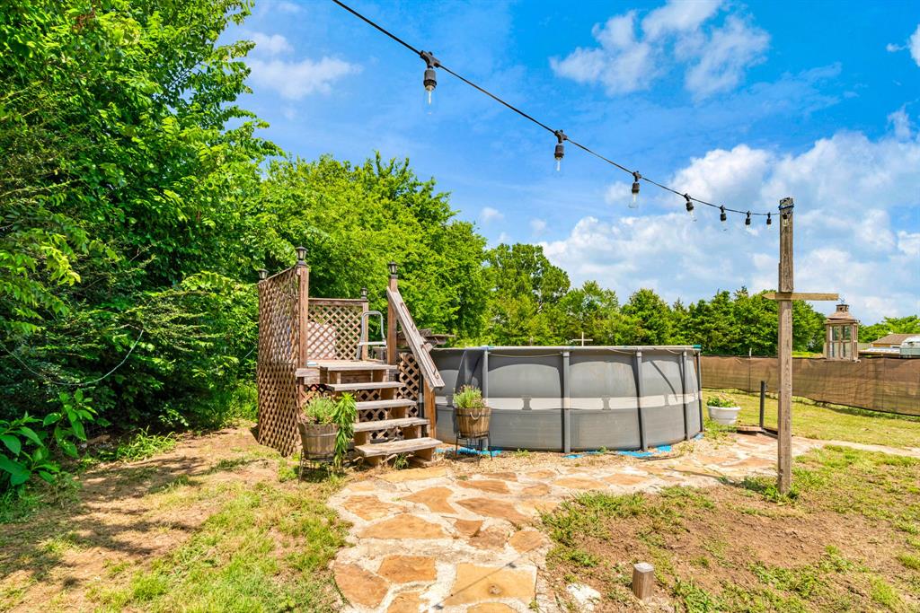 735 1st Southwest Detroit, TX 75436 - Photo 26 of 26 a view of a backyard with plants and a patio
