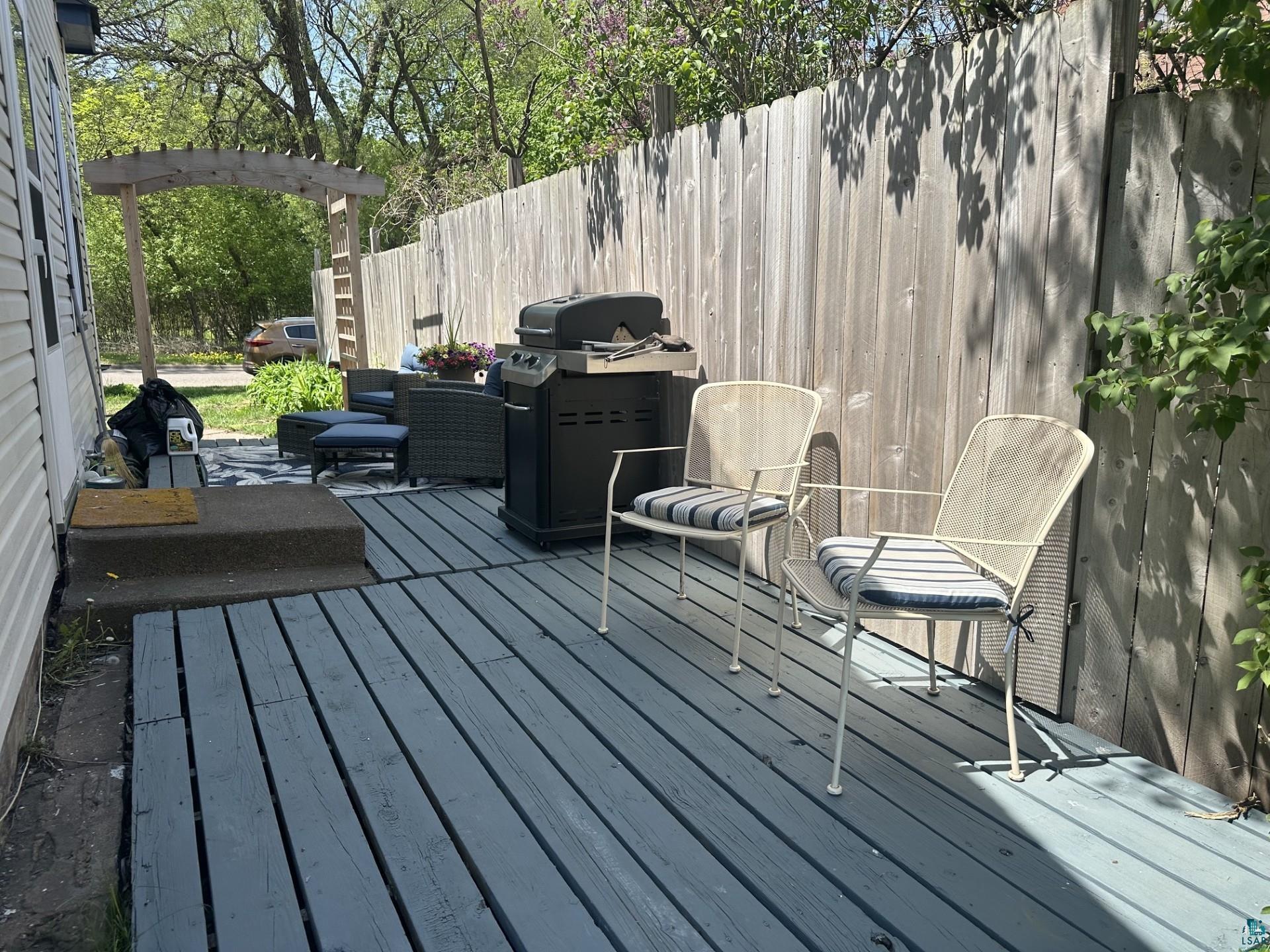 208 Chestnut Street Cloquet, MN 55720 - Photo 3 of 24 Expansive outdoor decking with a wood privacy fence