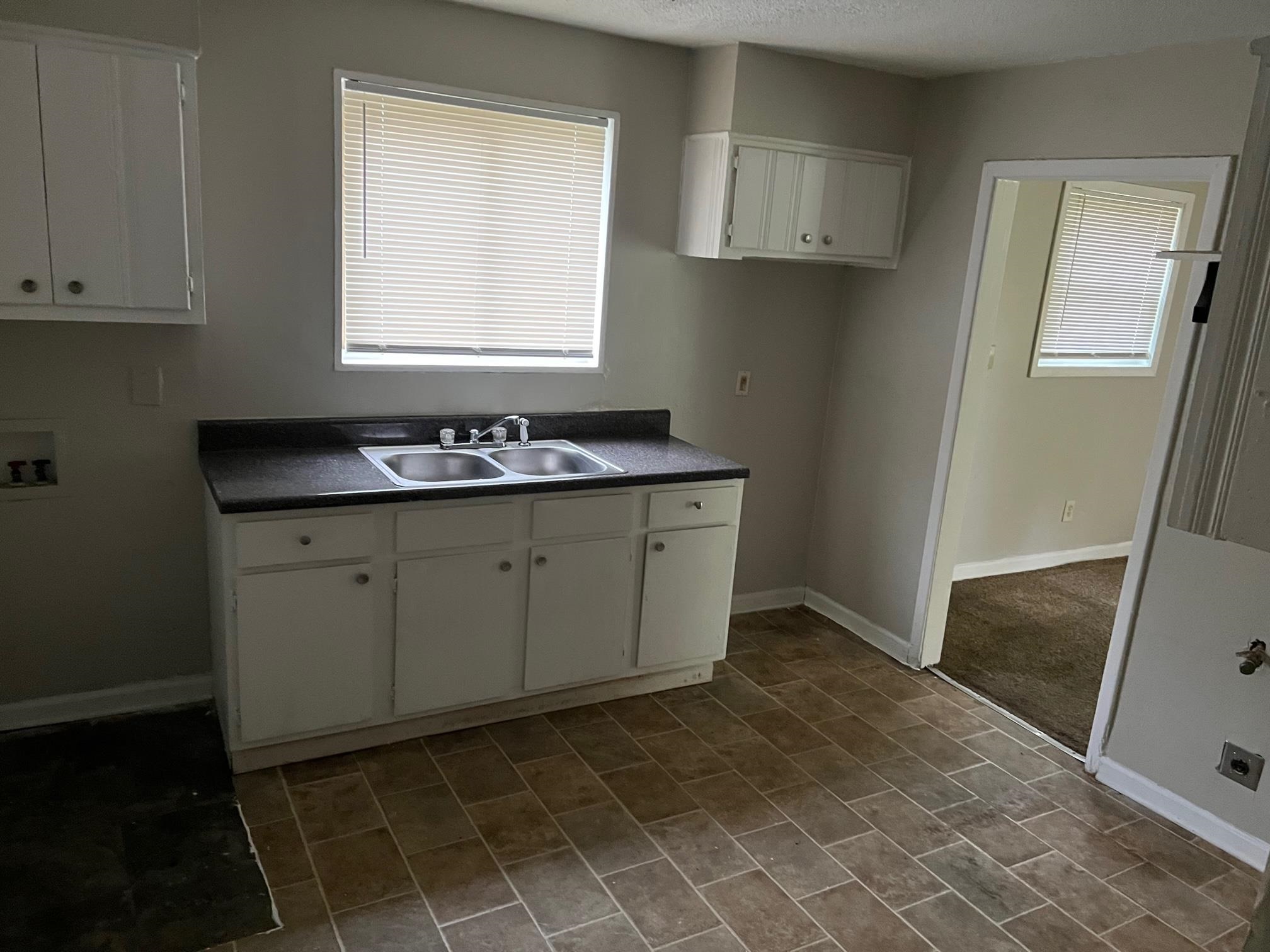 2457 Dwight Road Memphis, TN 38114 - Photo 4 of 8 a room with a sink cabinets and a window