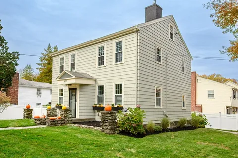 a view of a house with a backyard