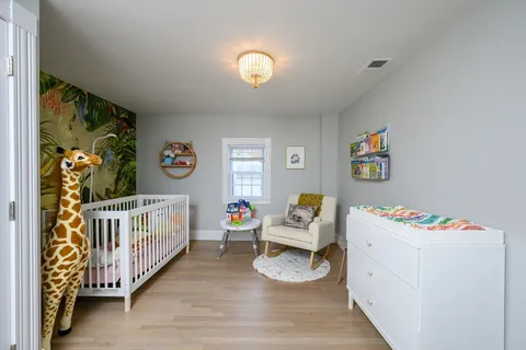 a bedroom with furniture and a wooden floor