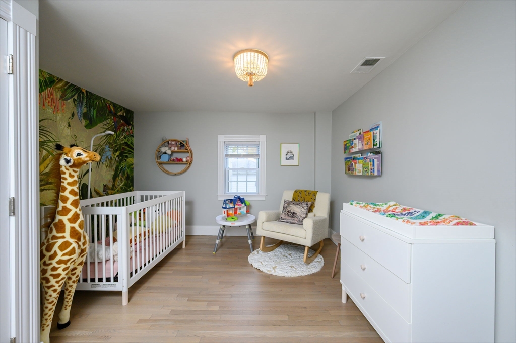 651 Canton Avenue Milton, MA 02186 - Photo 21 of 42 a bedroom with furniture and a wooden floor