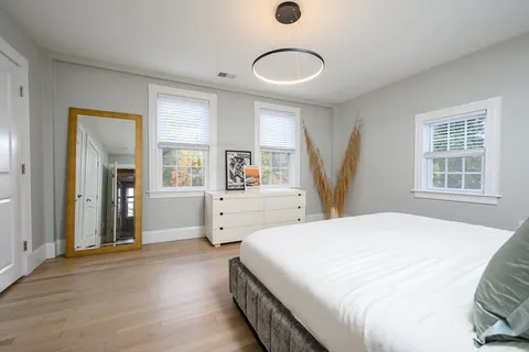 a spacious bedroom with a bed and a window