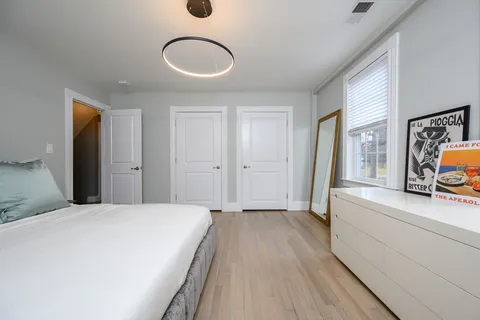 a spacious bedroom with a bed and a sink
