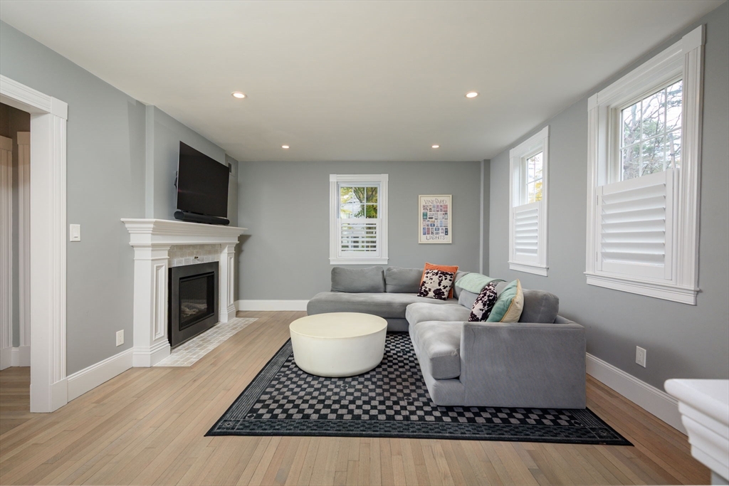 651 Canton Avenue Milton, MA 02186 - Photo 6 of 42 a living room with furniture a fireplace and a flat screen tv