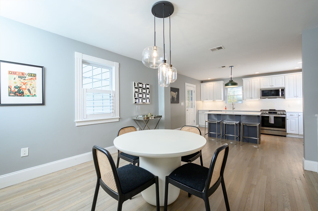 651 Canton Avenue Milton, MA 02186 - Photo 10 of 42 a view of a dining room with furniture and wooden floor