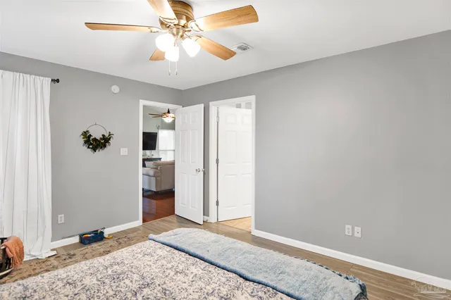 a view of a room with a chandelier fan and closet
