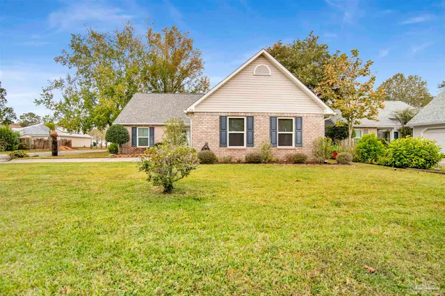 a view of a house with pool and a garden