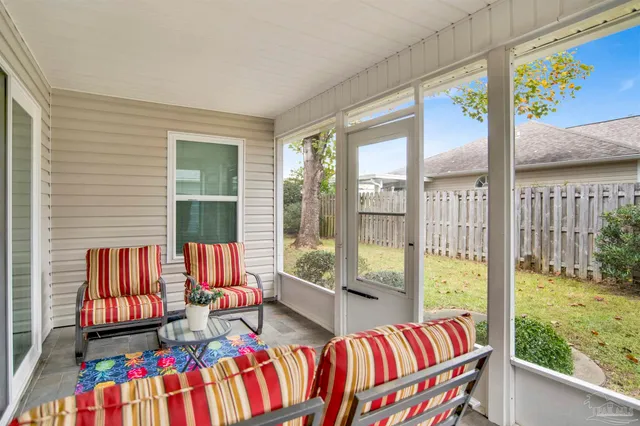 a living room filled with furniture and a floor to ceiling window