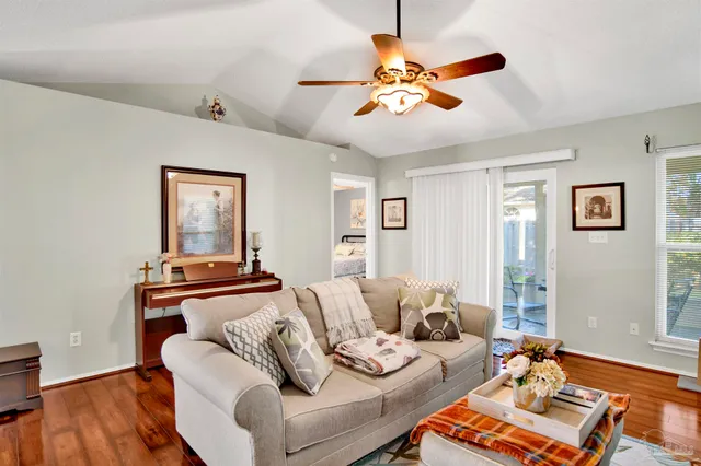 a living room with furniture and wooden floor