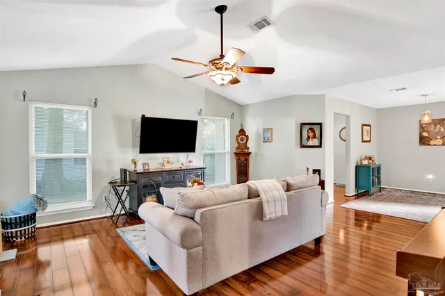 a living room with furniture and a flat screen tv