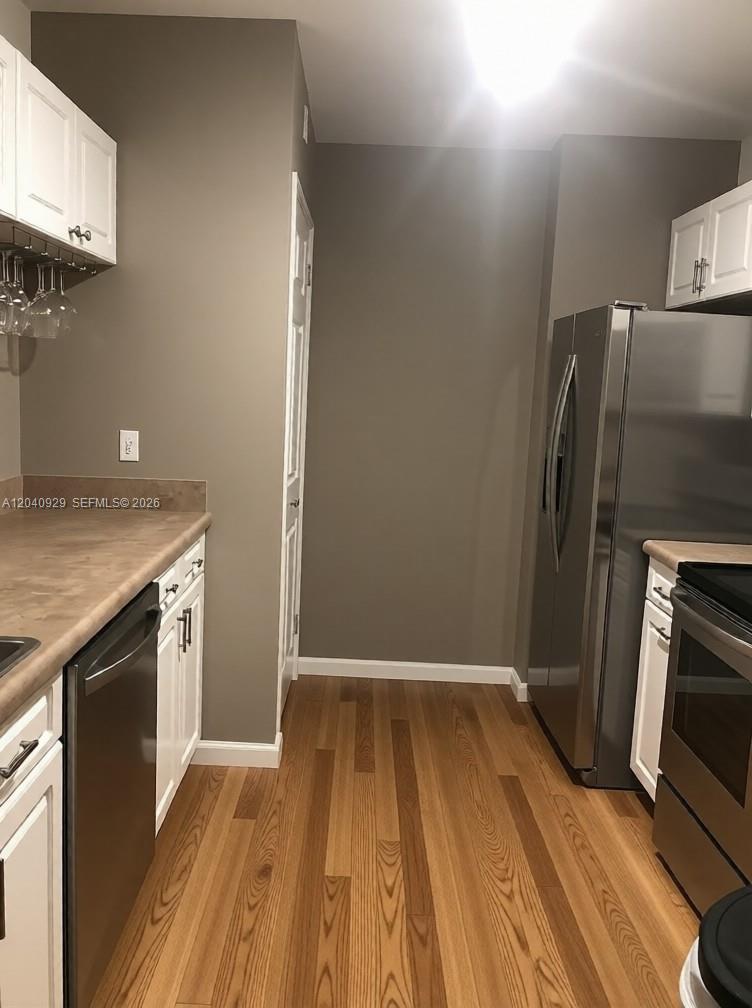 17145 North Bay Road Sunny Isles Beach, FL 33160 - Photo 6 of 6 a view of a kitchen with wooden floor and a sink