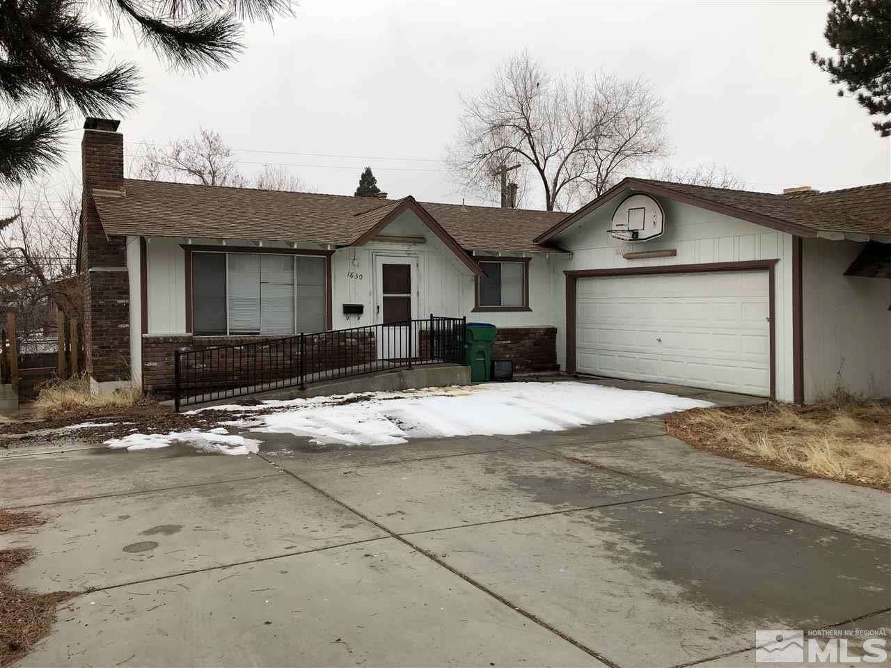 1830 Carlin Street Reno, NV 89503 - Photo 1 of 1 a front view of a house with a yard and garage