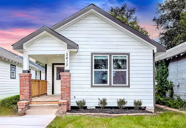 a front view of a house with swimming pool and glass windows
